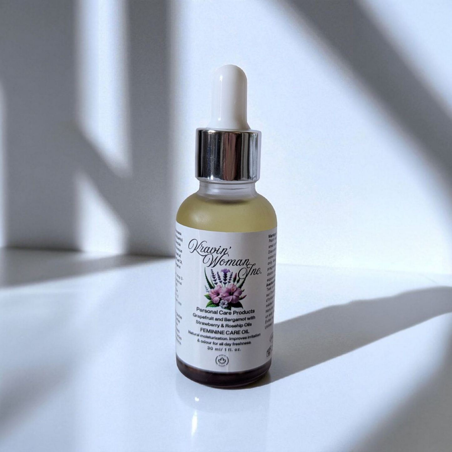 Luxury feminine care oil in frosted glass bottle by Kravin’ Woman Inc., Canada.