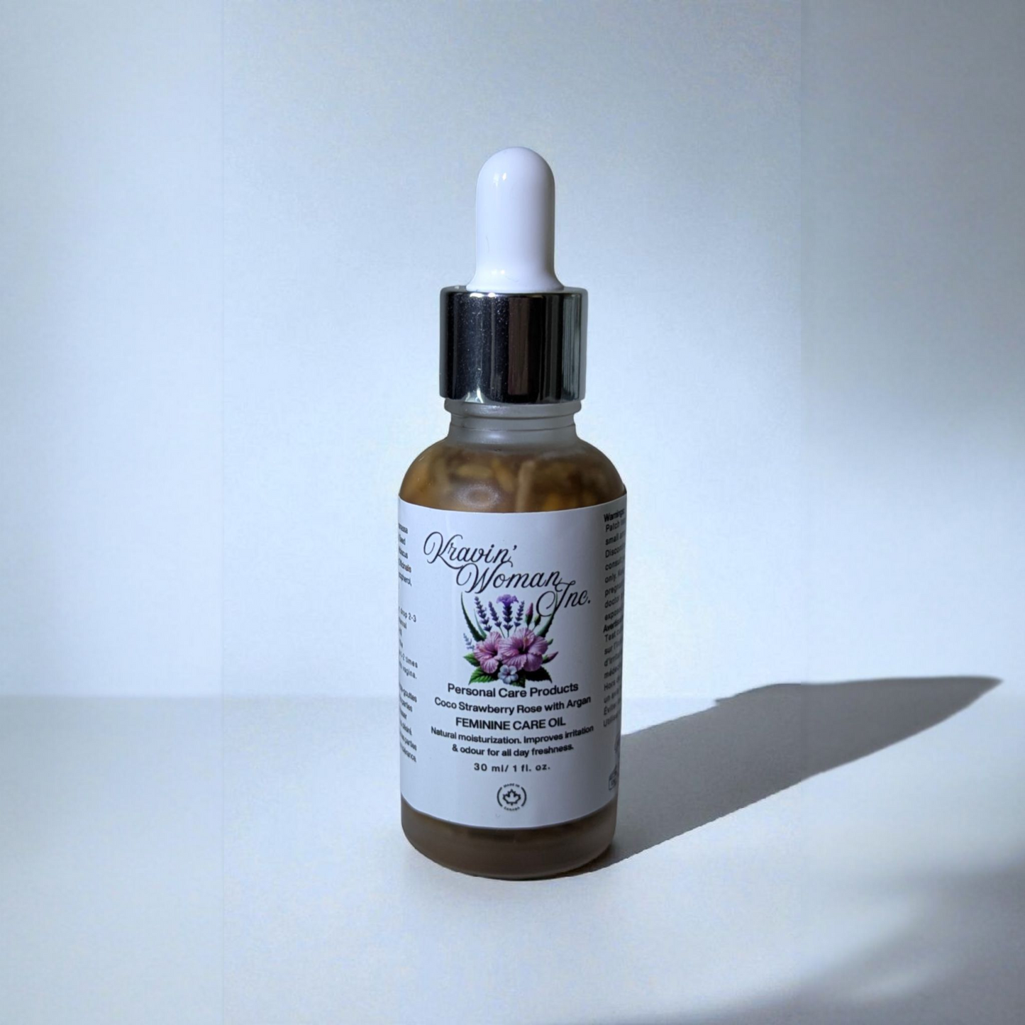 Luxury feminine care oil in frosted glass bottle by Kravin’ Woman Inc., Canada.